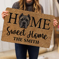 Person holding a Cane Corso doormat featuring a realistic dog portrait and bold black lettering
