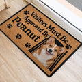 Corgi welcome mat placed near a doorway on light flooring, featuring paw prints and a framed dog portrait
