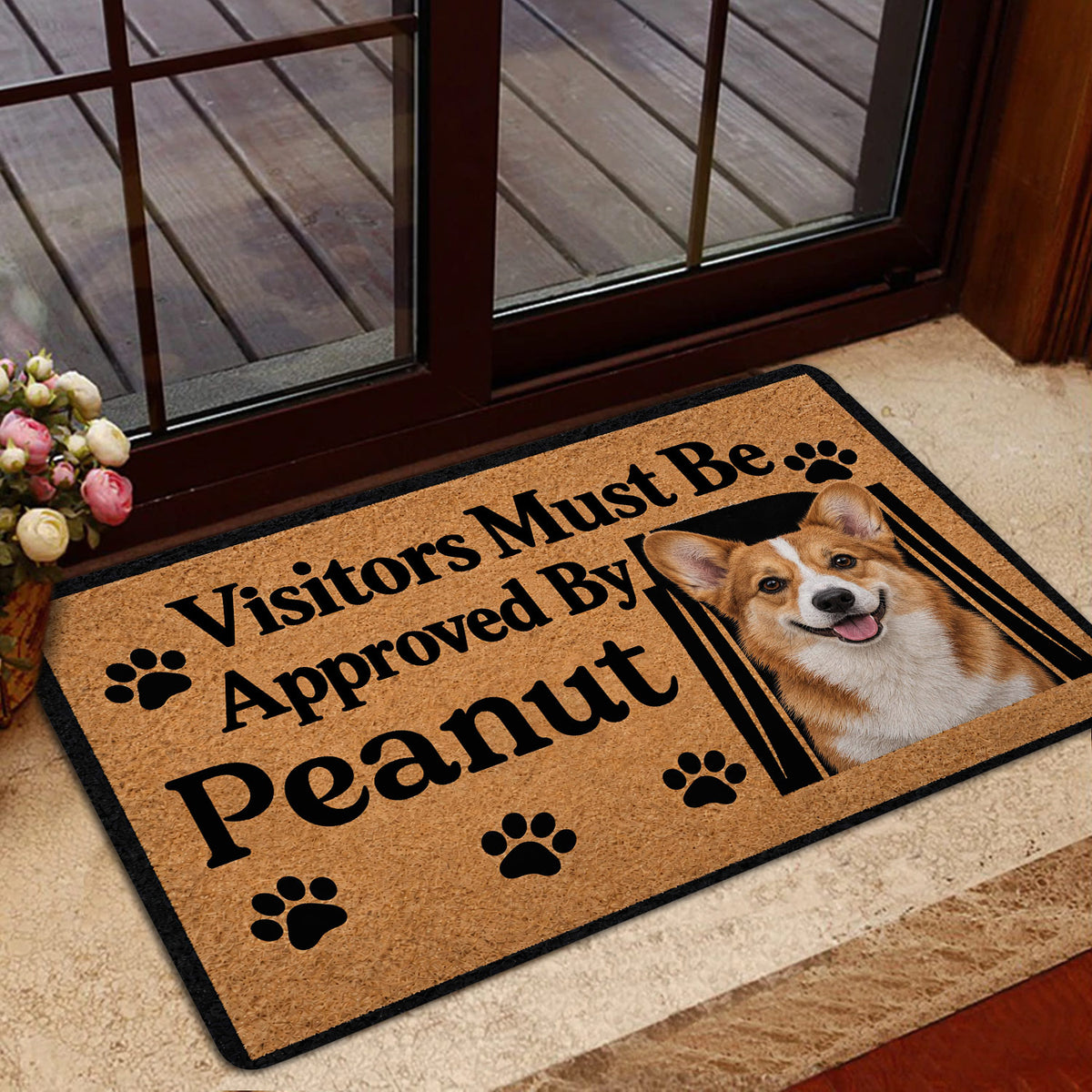 Corgi door mat shown in a home entrance beside glass doors, with tan artwork and black border