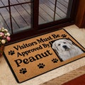 Great Pyrenees welcome mat styled inside a glass doorway beside a deck and home entrance