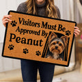 Person holding a tan Yorkie doormat featuring a Yorkshire Terrier portrait and paw prints