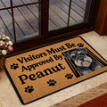 Miniature Schnauzer doormat styled inside a glass doorway with a wood deck visible outside