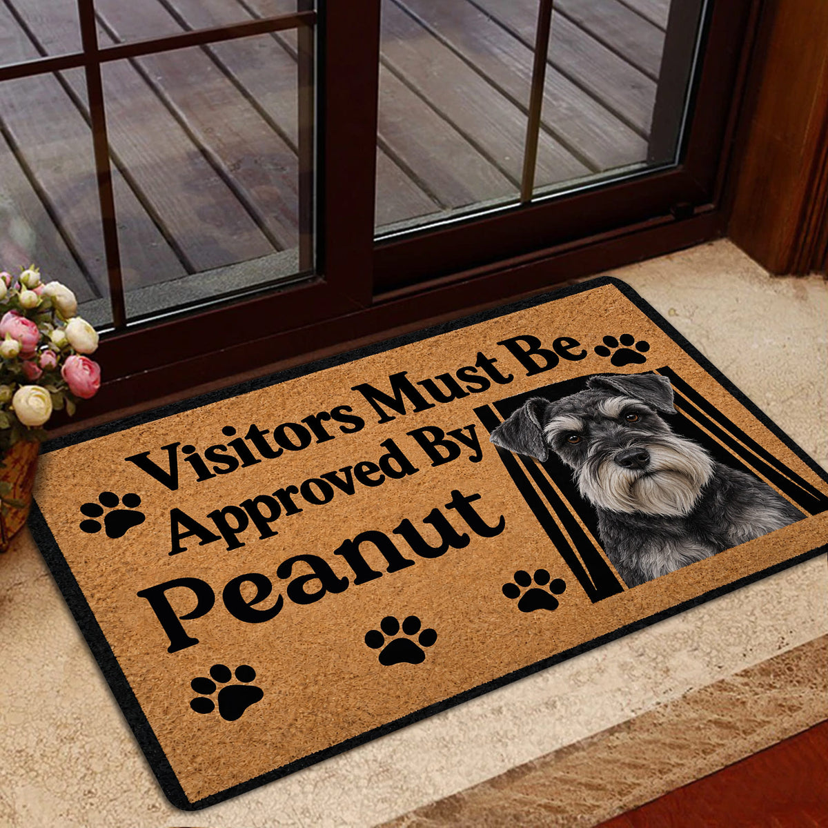 Miniature Schnauzer doormat styled inside a glass doorway with a wood deck visible outside