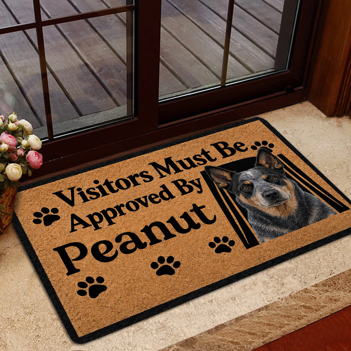 Australian Cattle Dog door mat styled at a glass entry door with tan artwork, black border, and paw prints