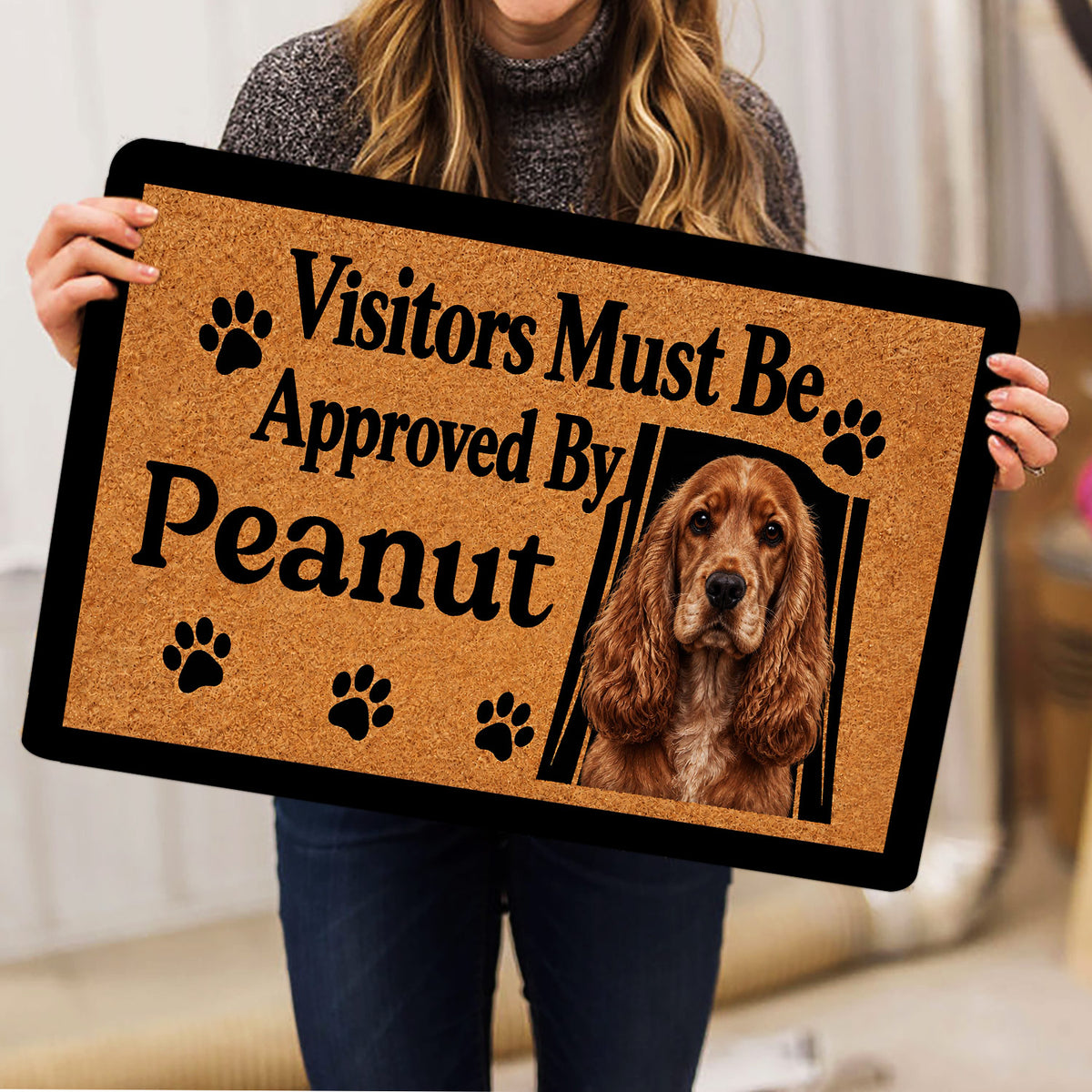 Person holding an English Cocker Spaniel doormat featuring a portrait and paw prints