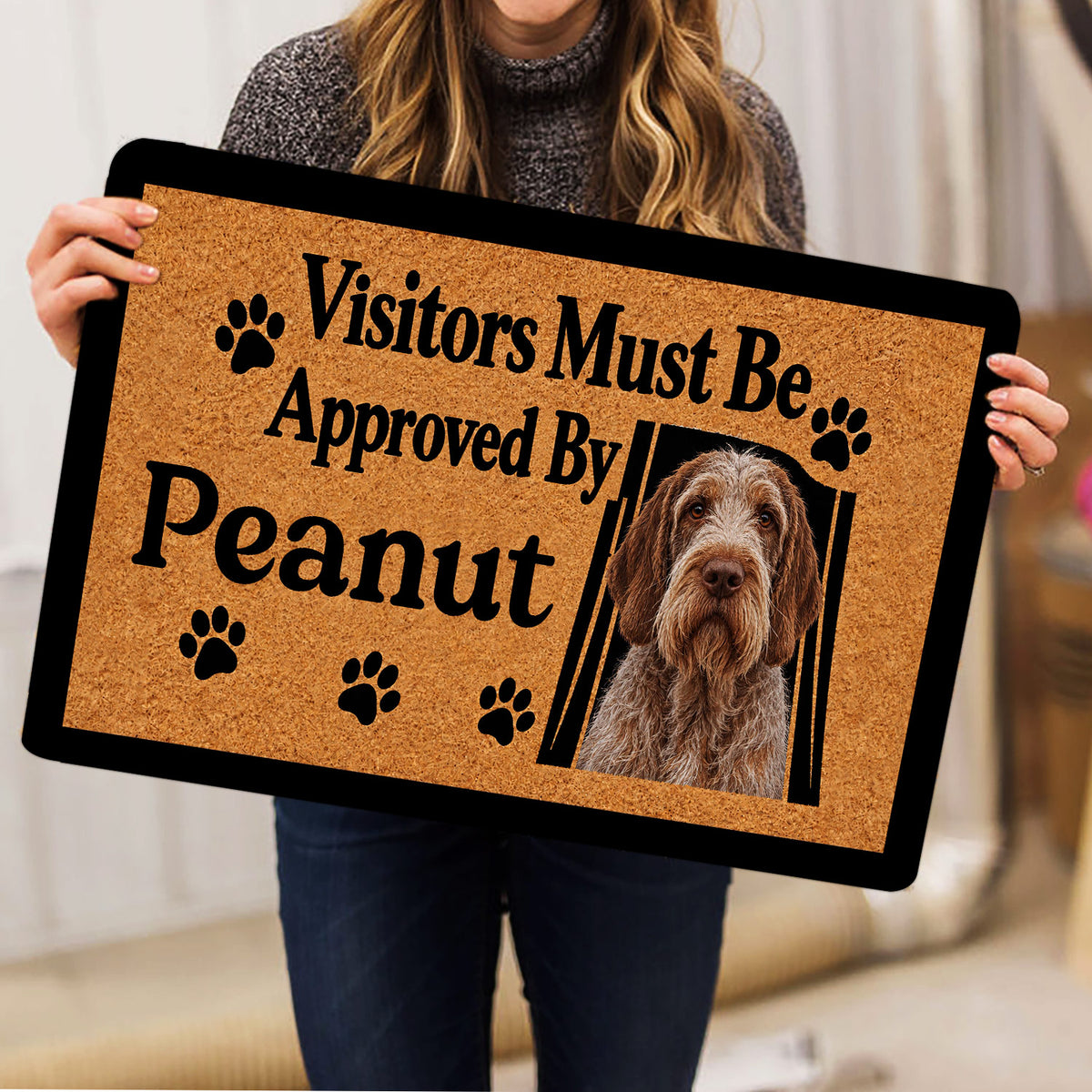 Spinone Italiano dog doormat held indoors, showing the portrait and paw-print artwork