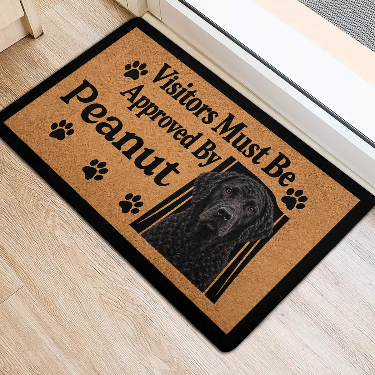 Curly Coated Retriever entryway rug shown at a doorway with paw prints and dog portrait
