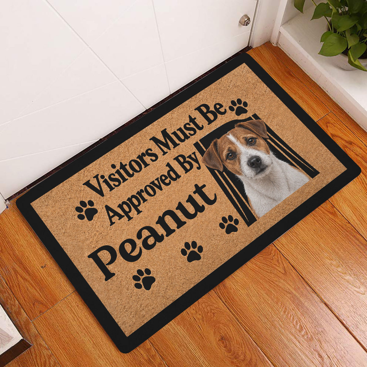 Jack Russell dog doormat displayed in a home entryway on a warm wood floor
