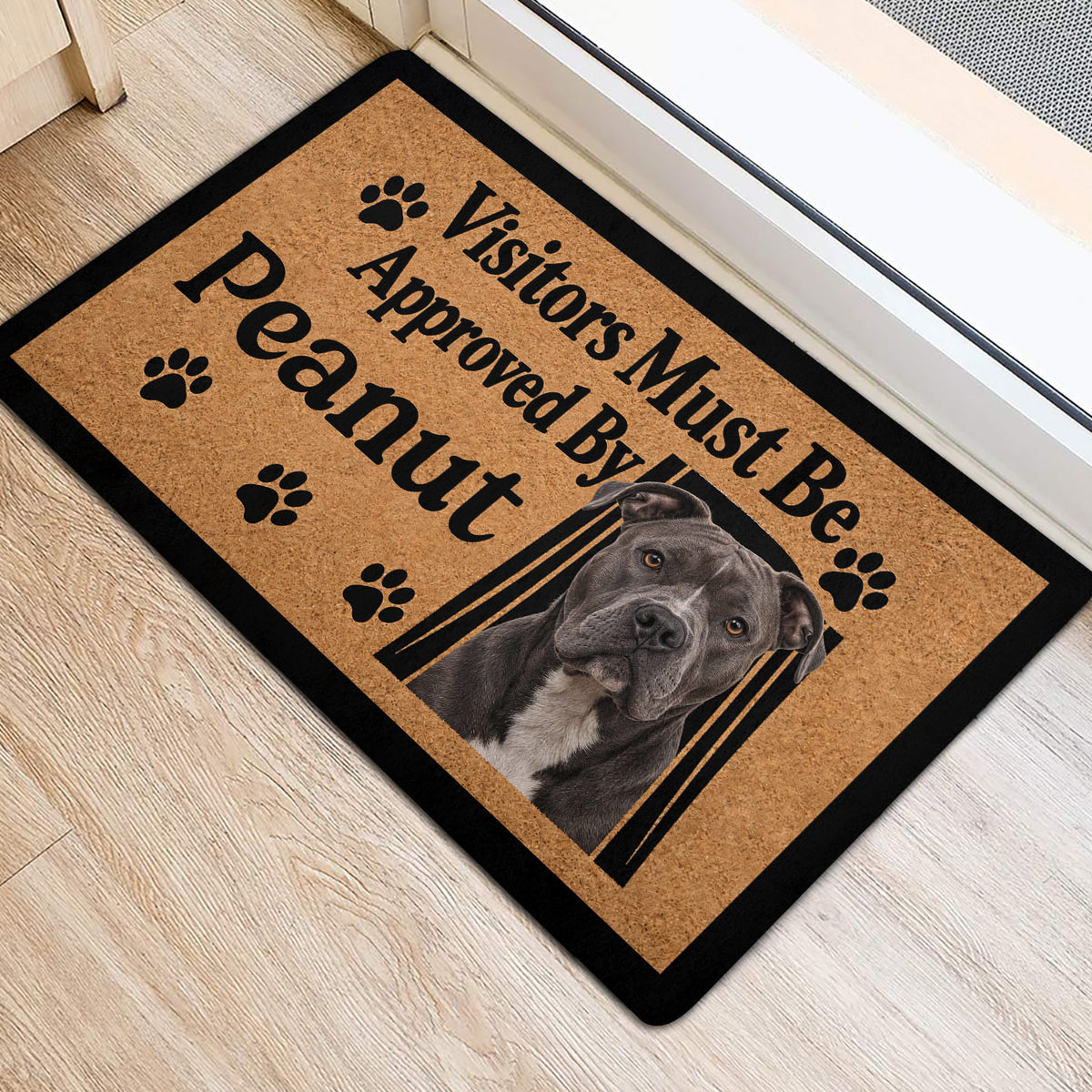 Pitbull welcome doormat positioned at an entryway, featuring paw prints, bold lettering, and a realistic dog portrait
