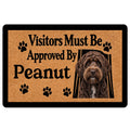 Labradoodle doormat with a curly-coated dog portrait, paw prints, and bold black lettering on a tan background