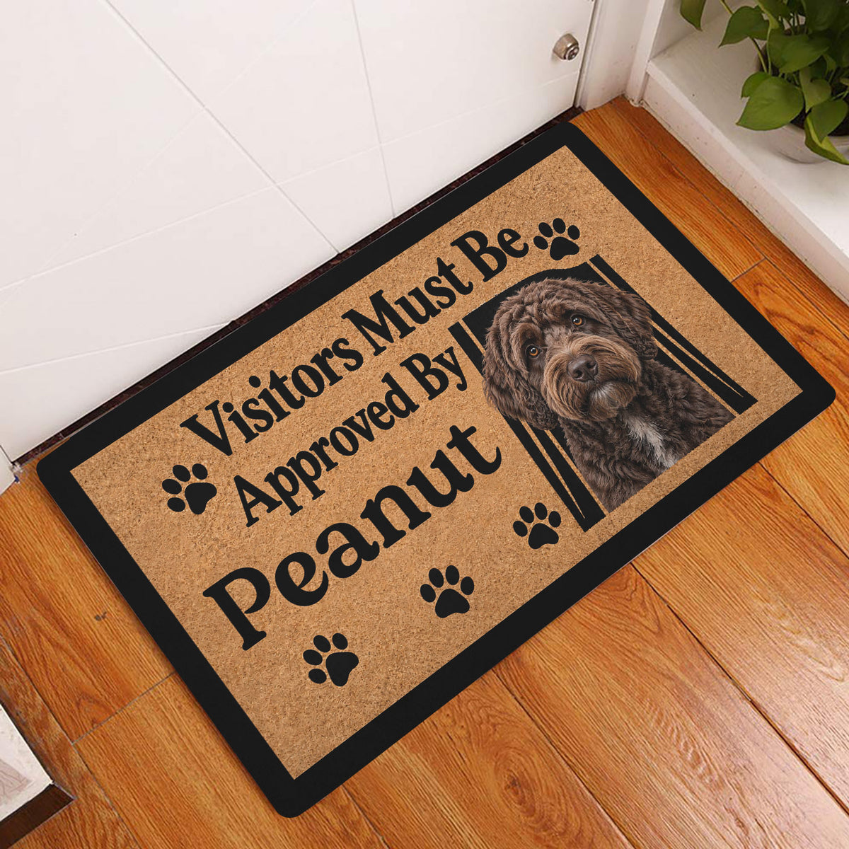 Labradoodle doormat displayed at an entryway on a wood floor beside a white door