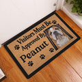 English Bulldog entryway mat displayed on a wood floor beside a white door