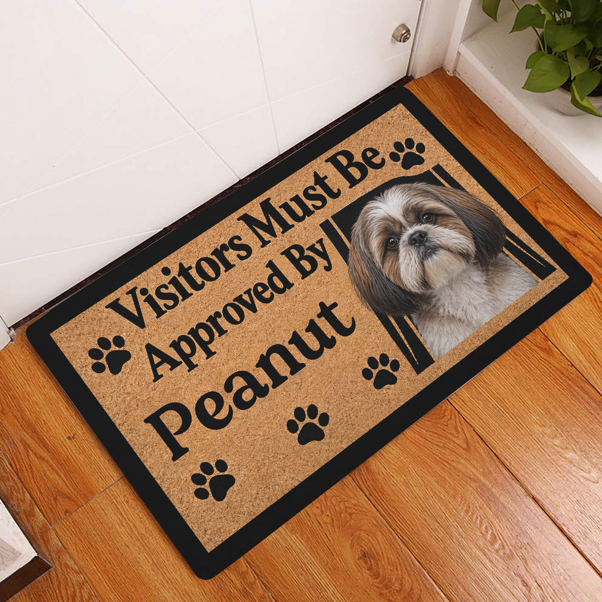 Shih Tzu doormat displayed in an entryway on hardwood flooring beside a white door