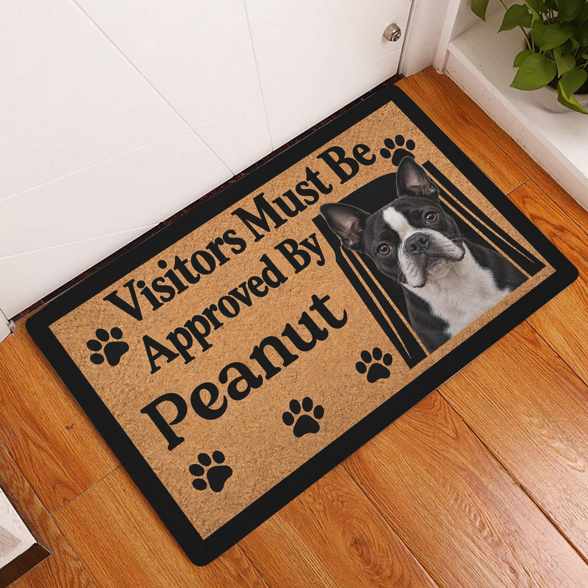 Boston Terrier welcome doormat displayed at a home entrance on a warm wood floor