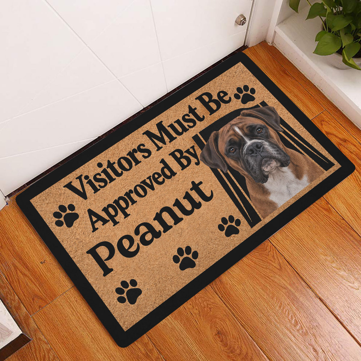 Boxer dog doormat displayed by a front door on a warm wood entryway floor