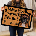 Person holding a Boxer dog doormat featuring a portrait, paw prints, and bold lettering