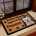 Westie door mat displayed near a glass entry door with a white terrier portrait and paw print design