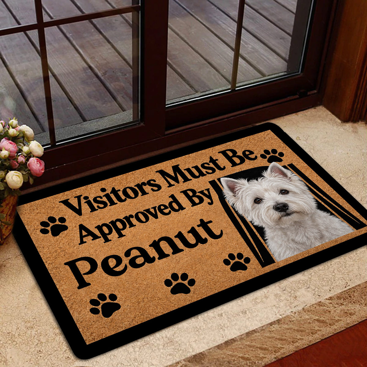 Westie door mat displayed near a glass entry door with a white terrier portrait and paw print design