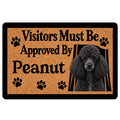Poodle doormat with black curly dog portrait, paw prints, and bold welcome message on a tan background