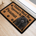 Poodle door mat positioned by a doorway, featuring paw prints, tan artwork, and black border