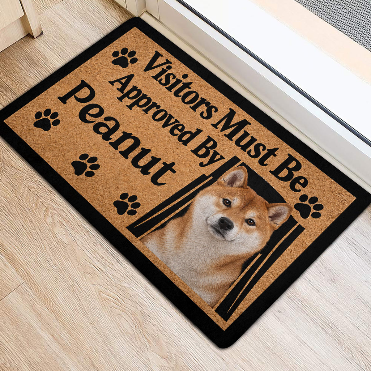 Shiba Inu welcome mat displayed near a bright doorway with paw-print accents