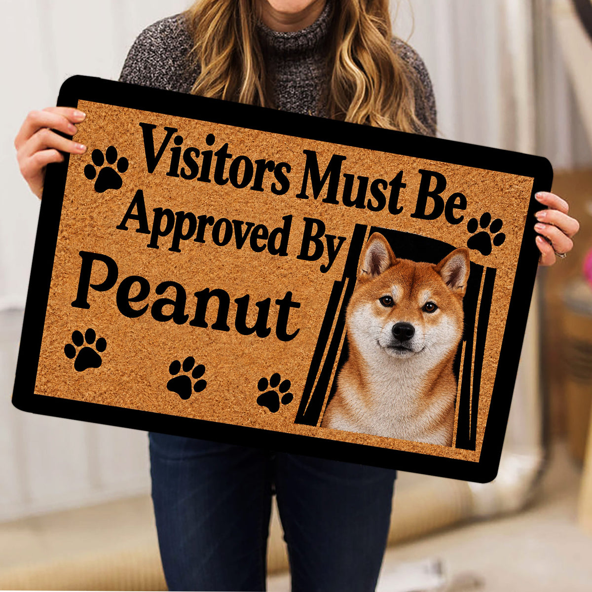 Shiba Inu doormat held indoors, showing the tan artwork, black border, and portrait design