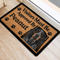 Bluetick Coonhound entryway rug shown beside a doorway with paw-print artwork