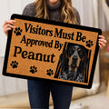 Person holding a Bluetick Coonhound doormat featuring a hound portrait and paw prints
