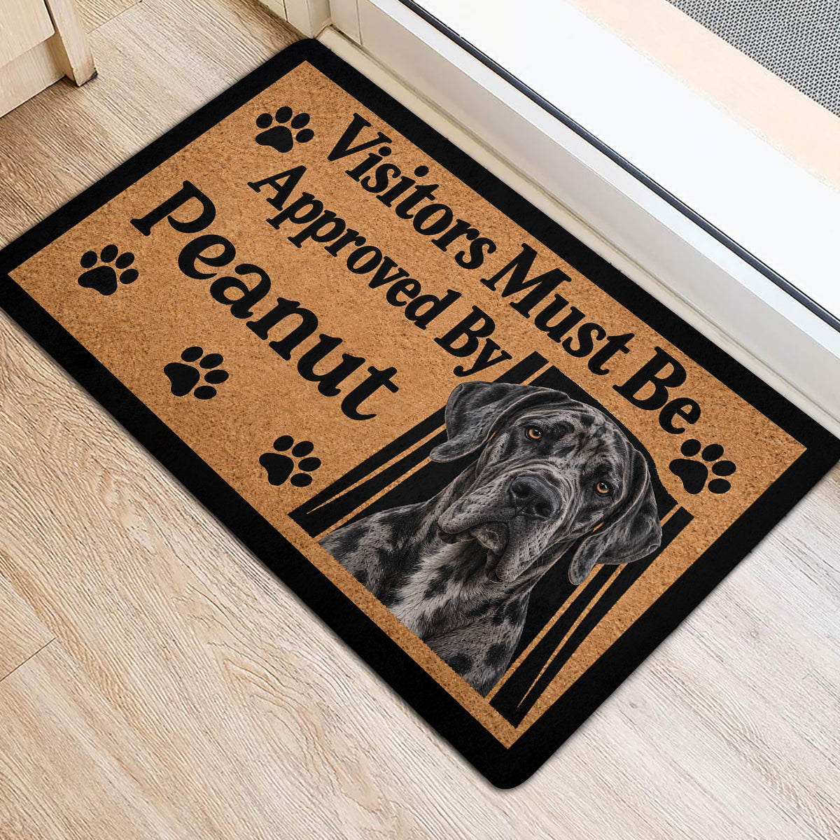 Great Dane door mat arranged at an entrance on light wood flooring with paw print artwork