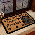 Dutch Shepherd door mat positioned by a glass entrance with tan artwork and black border