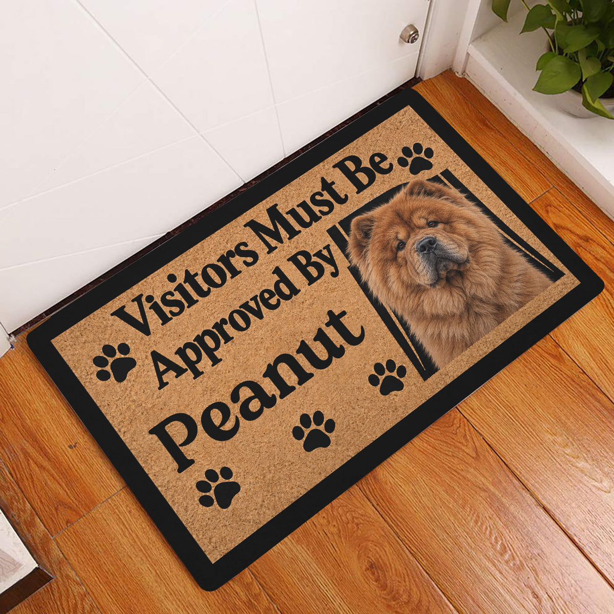 Chow Chow entryway mat displayed on a warm wood floor beside a white door and indoor plant