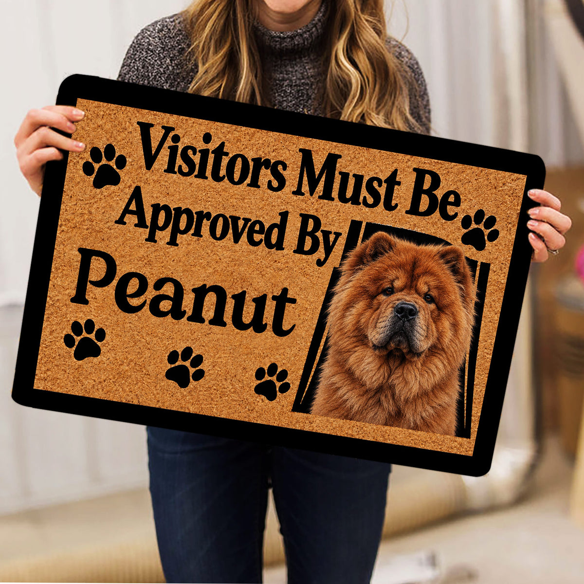 Person holding a Chow Chow doormat featuring a fluffy dog portrait, paw prints, black border, and bold welcome message