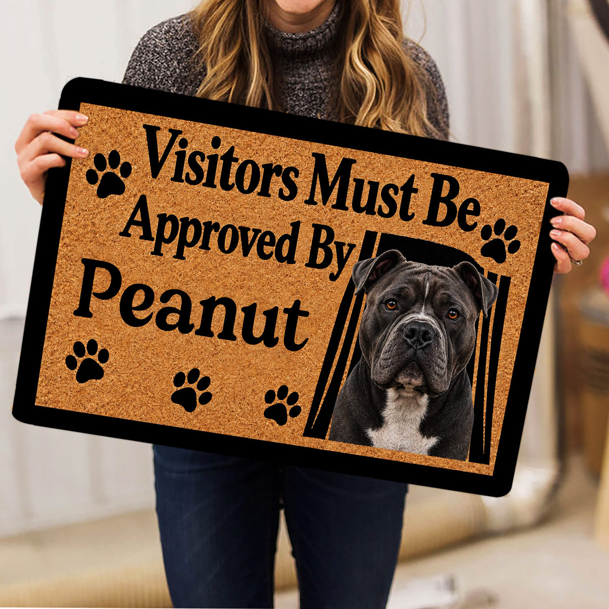 Person holding an American Bully doormat featuring a realistic dog portrait and paw print accents