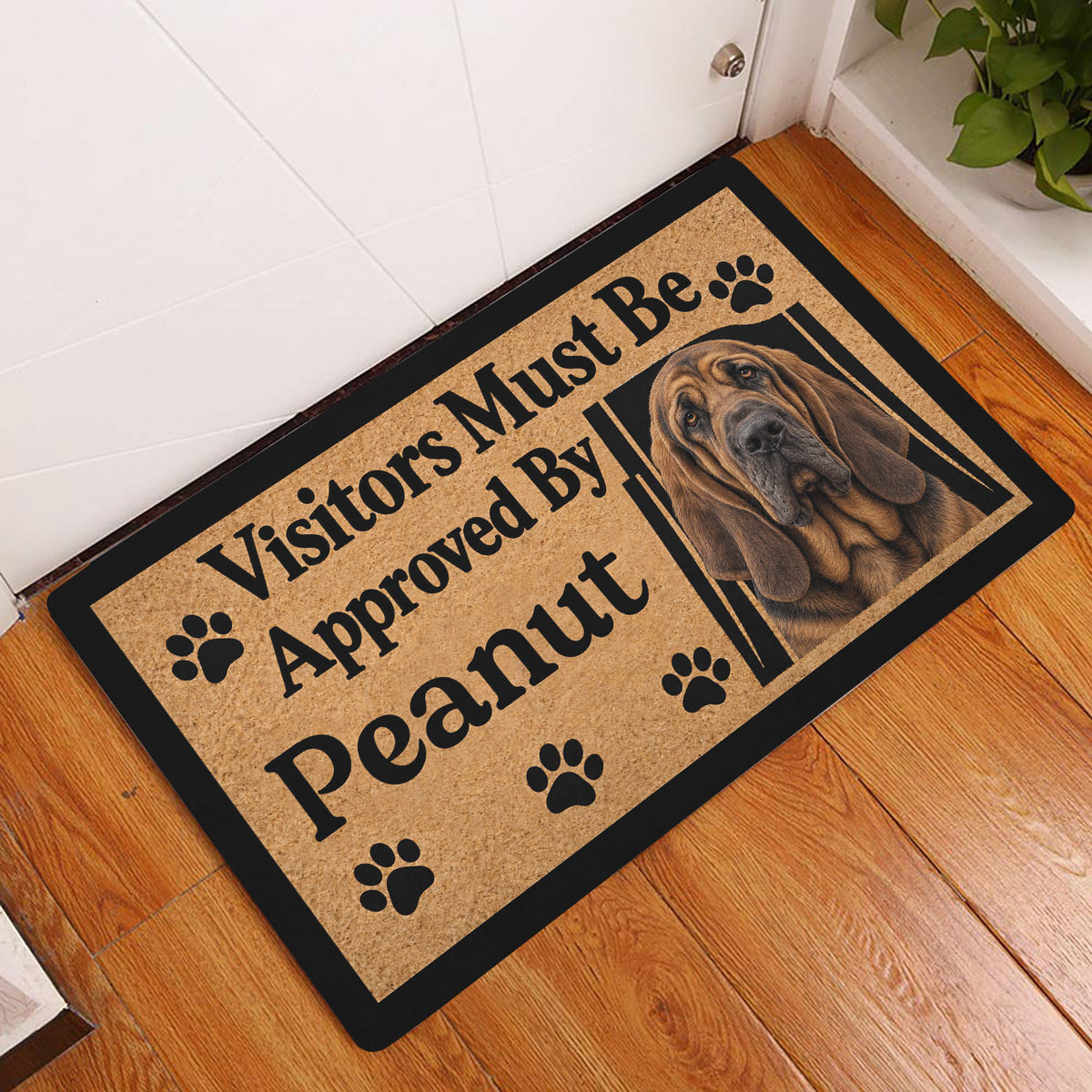 Bloodhound doormat displayed beside a doorway on a warm wood floor