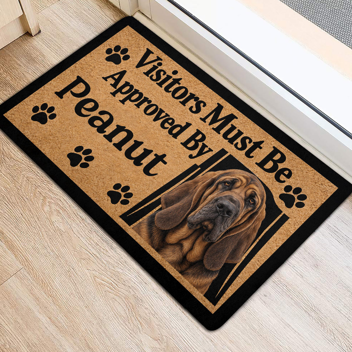 Bloodhound entryway mat positioned near a doorway with paw prints and portrait artwork
