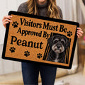 Person holding a Schnoodle dog doormat featuring a portrait and paw prints