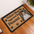 Papillon dog entryway mat displayed on a wood floor beside a white door