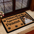 Papillon dog doormat styled at a glass entry door with a warm home interior