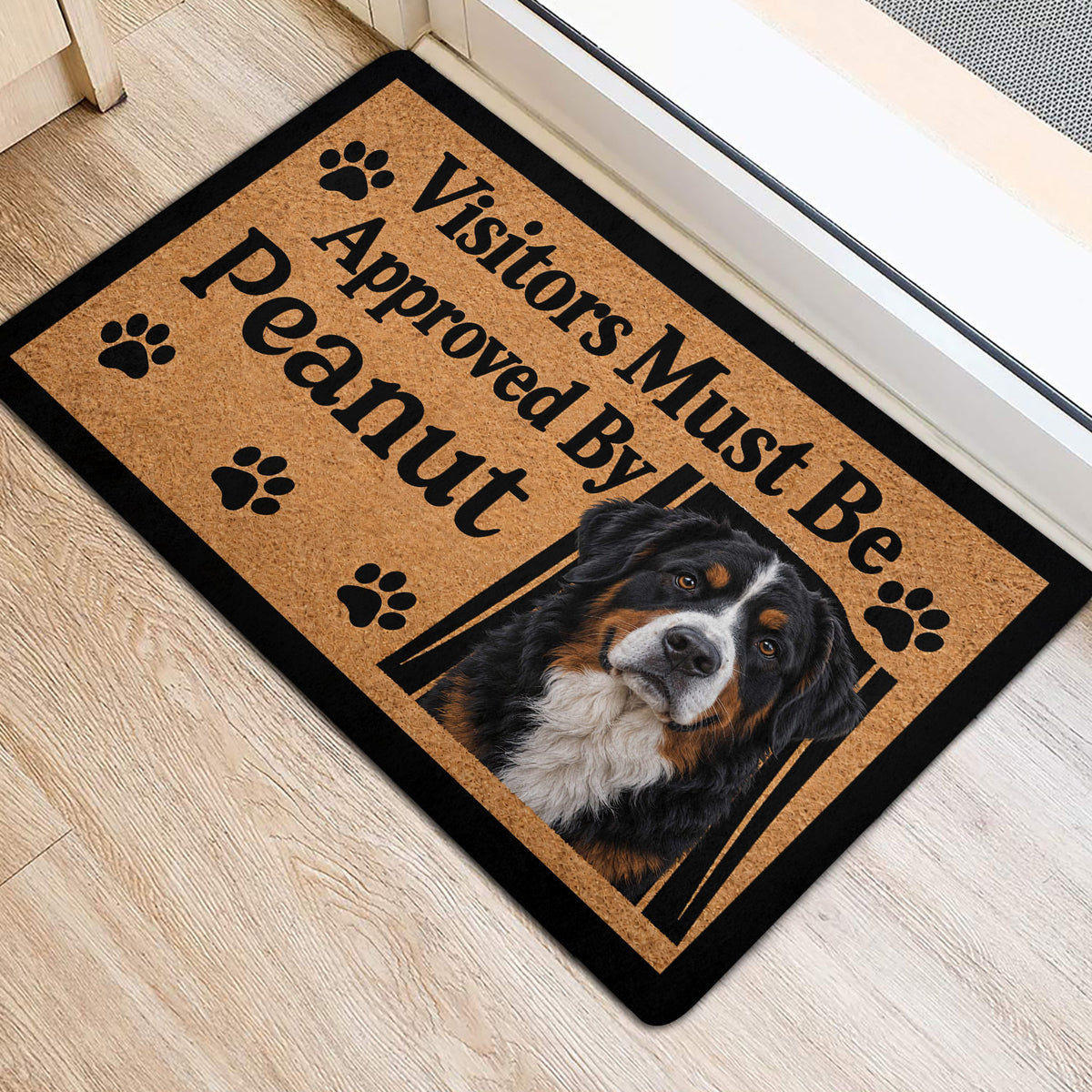 Bernese Mountain Dog door mat placed near an entryway door with paw print accents and black border