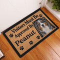 Australian Shepherd doormat displayed by a white door on a wood floor in an indoor entryway