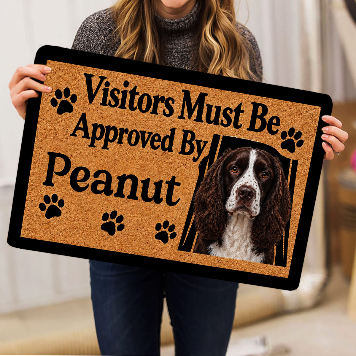 English Springer Spaniel doormat held indoors, showing the dog portrait and paw-print design