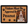 Brittany Spaniel doormat with paw prints, tan textured artwork, black border, and playful visitor message