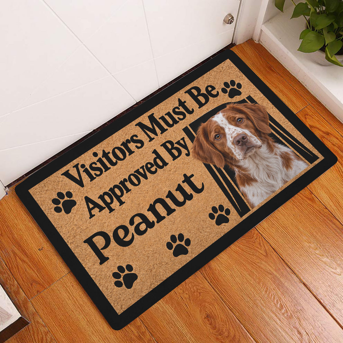 Brittany Spaniel doormat styled in a warm wood-floor entryway beside a white door