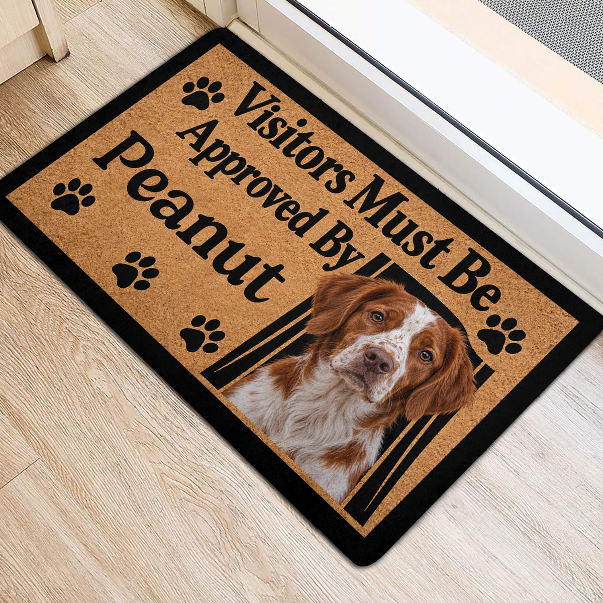 Brittany Spaniel front door mat with paw prints and portrait artwork in a bright entryway