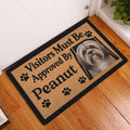 Lhasa Apso dog doormat displayed in a home entryway on warm wood flooring