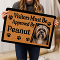 Person holding a Lhasa Apso dog doormat featuring a portrait, paw prints, and bold lettering
