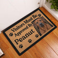 Rhodesian Ridgeback doormat displayed in an indoor entryway beside a white door and wood floor