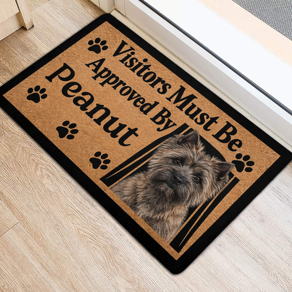 Cairn Terrier entryway mat with paw prints and portrait artwork near a doorway