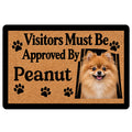 Pomeranian doormat with cheerful dog portrait, paw prints and playful welcome message on a tan background