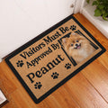 Pomeranian entryway doormat displayed beside a white door on a warm wood floor